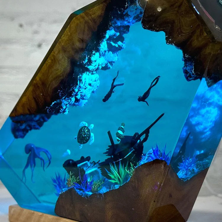 Wooden sculpture with blue resin and underwater scene, including fish and a turtle.