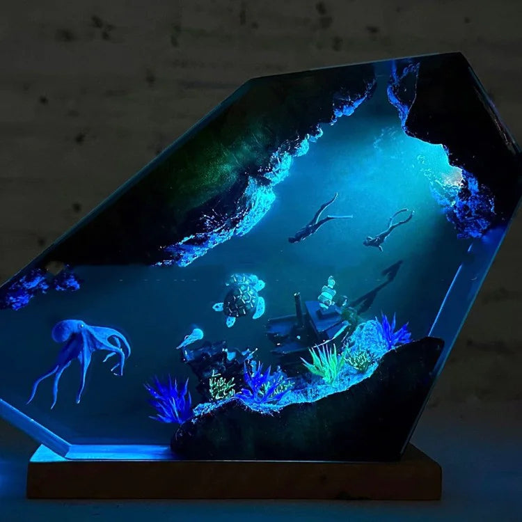 3D aquarium display with underwater scene, including fish and coral, on a dark background.
