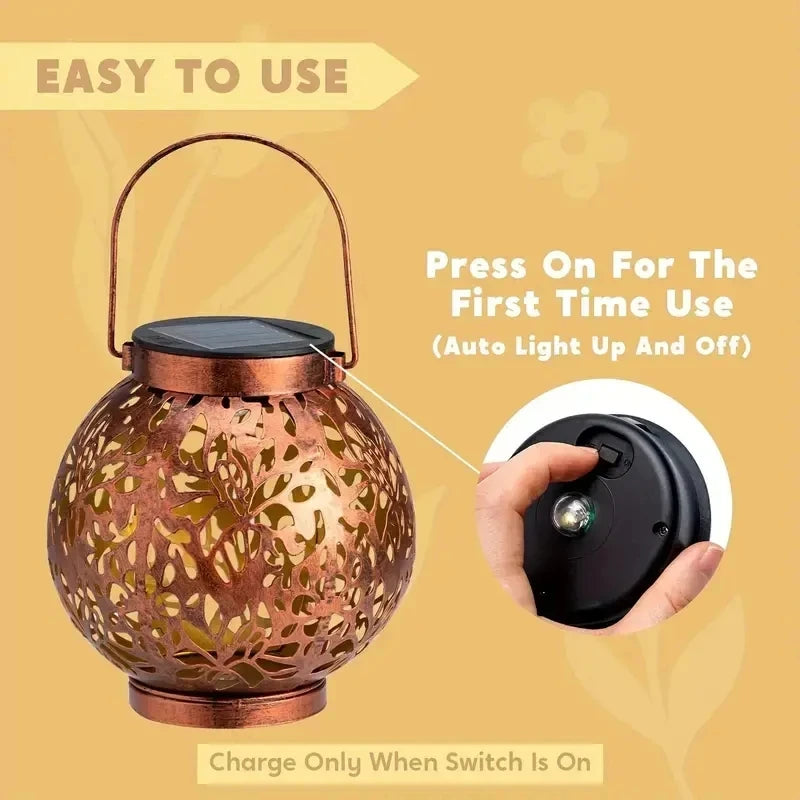 Two bronze solar hanging lantern lights with a geometric pattern design, illuminated and projecting shadows on the ground.