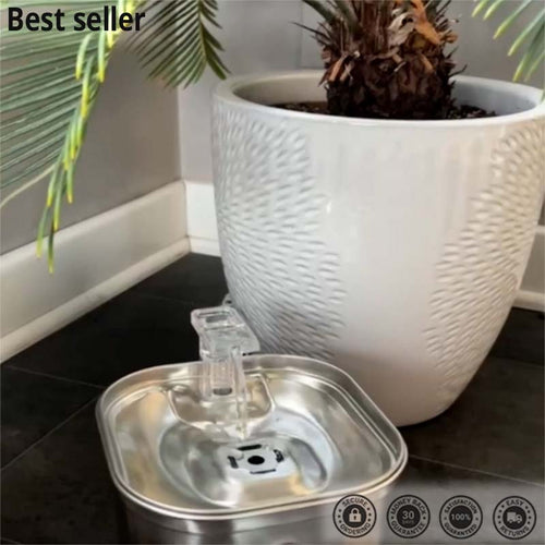 Metal water fountain with a white textured planter and plant in the background, labeled 'Best seller'.
